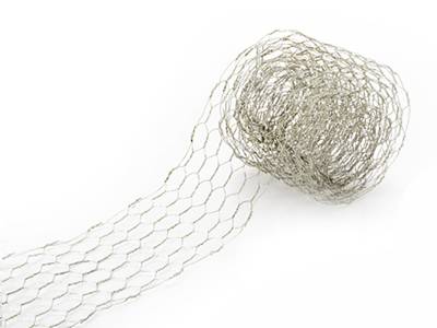 A roll of chicken wire ribbon is lying there with part of ribbon extended.