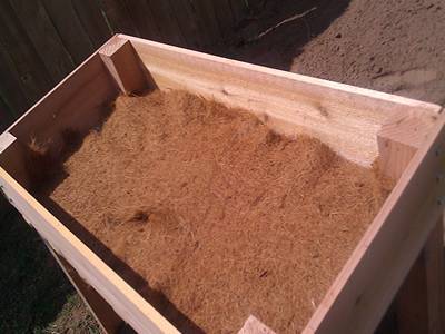 A layer of covering is placed on the raised bed for supporting soils.